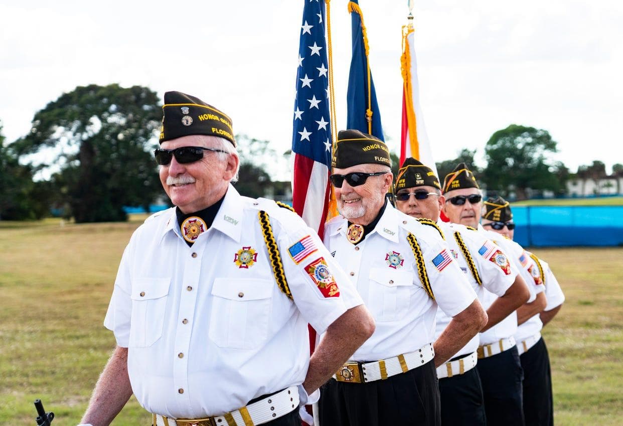 VFW Honor Guard member presenting the American flag