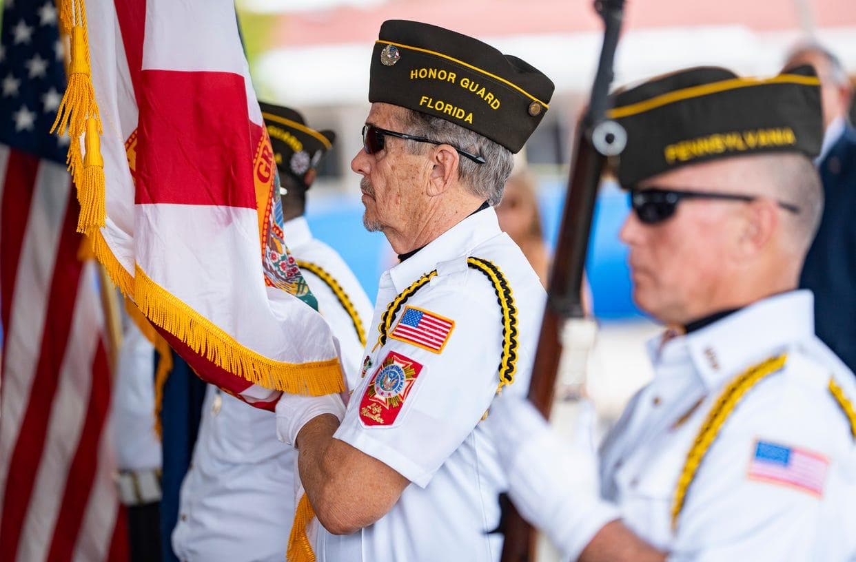 VFW Honor Guard members standing with the American flag